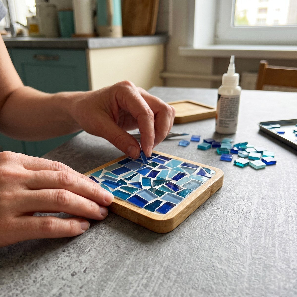 Glass mosaic coaster beside a crossword and glasses